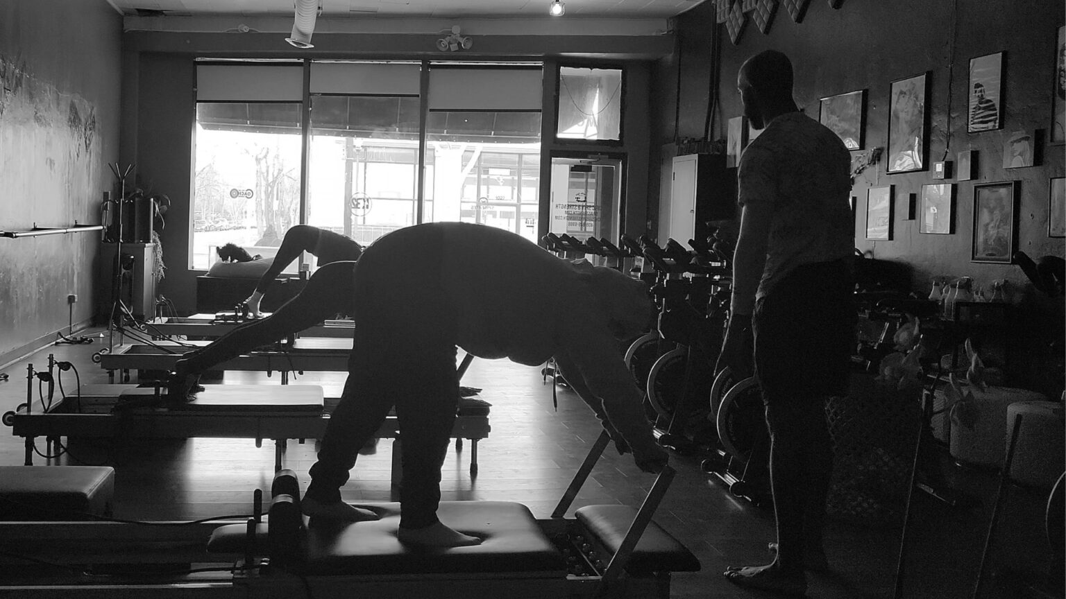 Happy clients working on a Reformer Pilates machine after a successful back pain relief session.